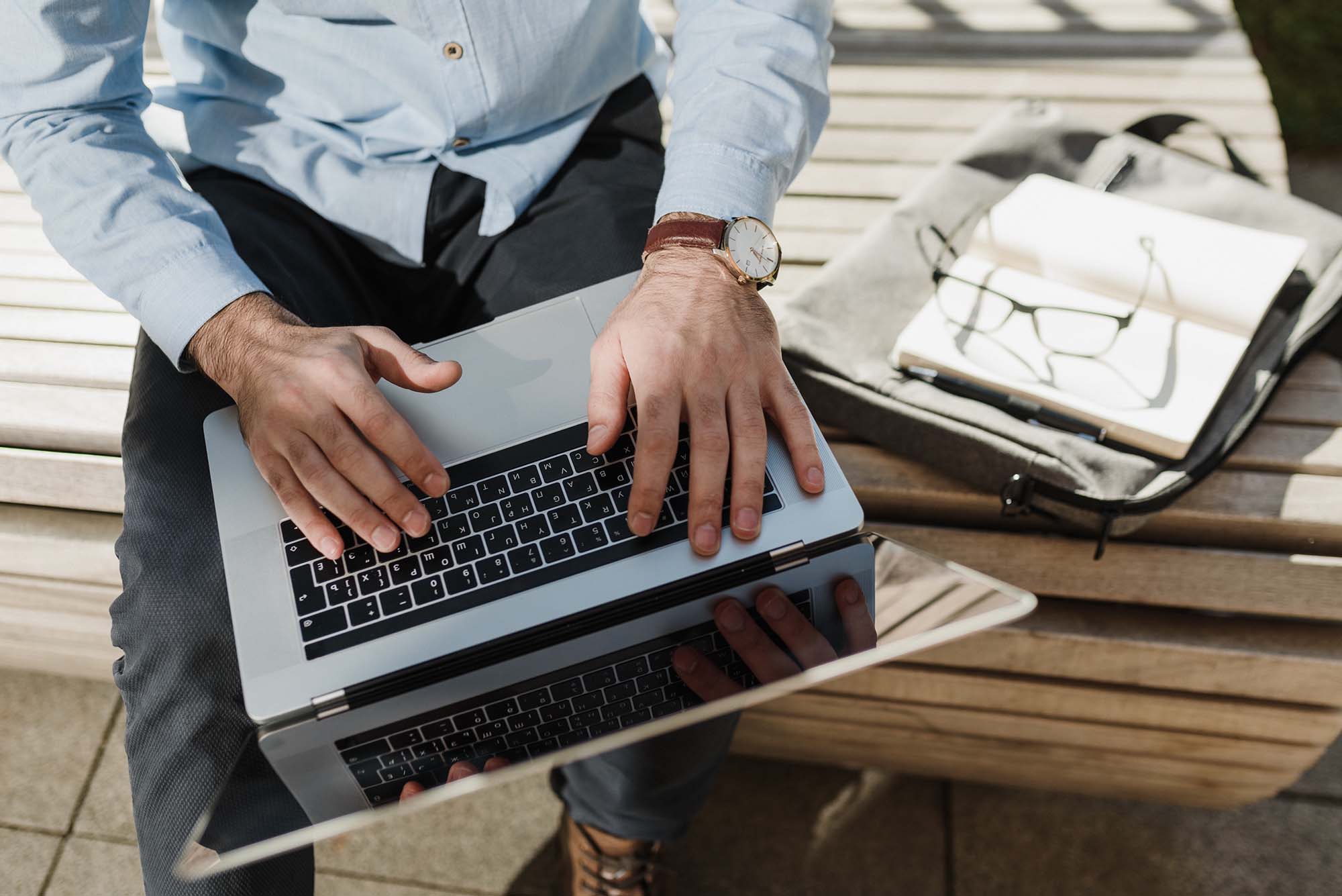 Overhead photo of hands on a laptop keyboard